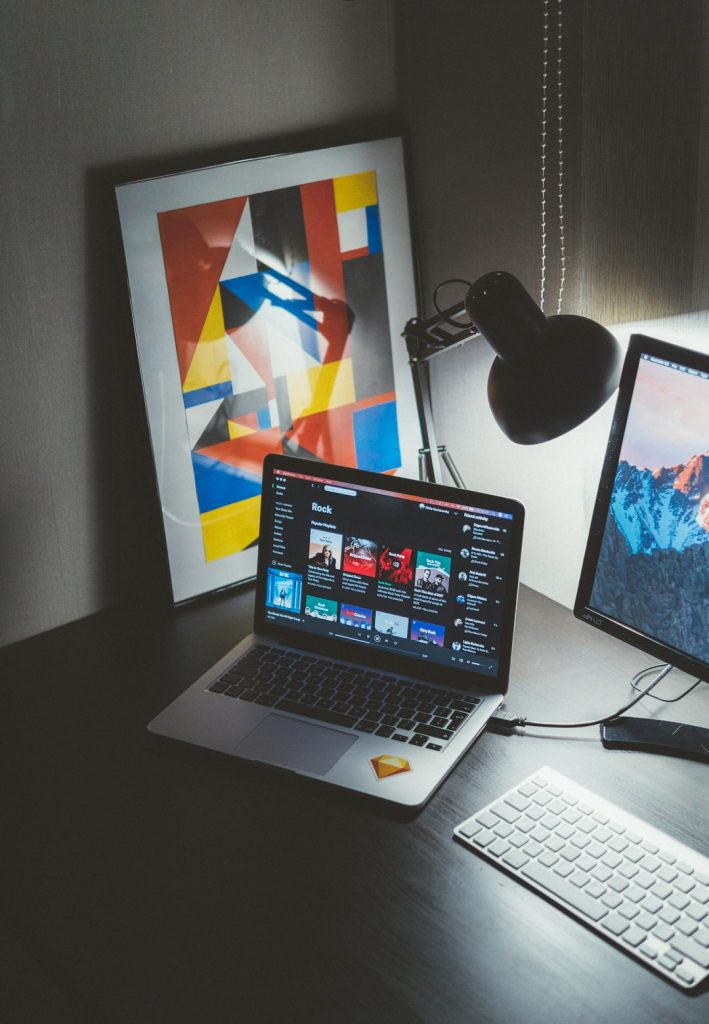turned-on-macbook-on-table-beside-imac-g-yix8ynmny